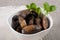 Grilled champignons in a white plate on a fabric background