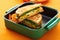 grilled cheese sandwich packed in a green lunchbox