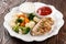 Grilled chicken breast fillet with stew vegetables and sauces
