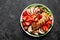 Grilled chicken breast and strawberry salad with red apples, fresh spinach and nuts