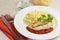 Grilled chicken escalope with tomato sauce and pasta