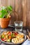 Grilled chicken with grilled vegetables on a wooden background. Healthy eating