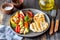 Grilled chicken with grilled vegetables on a wooden background. Healthy eating