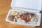 Grilled Chicken meat rice with black soy sauce egg on polystyrene box.