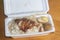 Grilled Chicken meat rice with black soy sauce egg on polystyrene box.