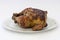 Grilled Chicken (pollo a la brasa) on white plate.