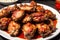 Grilled chicken wings with sweet and sour sauce on a white plate.Grilled sausages , Delicious barbecue ribs. Generative AI