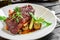 Grilled chuck beef steak with vegetables on plate