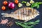 Grilled dorada fish with fresh vegetables and herbs