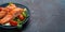 Grilled fish salmon steak with vegetables salad on ceramic plate on rustic stone background angle view, balanced diet