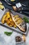 Grilled fish on stone plate with lemon on concrete background.