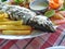 Grilled fish with vegetables and french fries in restaurant. Goa.