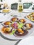 Grilled Galician Scallops, seafood salad and white wine on white backgound. Iberic Variegated Scallops ZamburiÃ±as