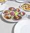 Grilled Galician Scallops, seafood salad and white wine on white backgound. Iberic Variegated Scallops ZamburiÃ±as