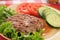 Grilled ground beef patty with vegetables