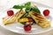 Grilled Halloumi cheese on grilled vegetables with basil