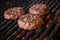 Grilled hamburgers on charcoal coals