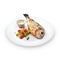 Grilled healthy dorado fish with vegetables on a round plate