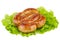 Grilled homemade sausage over fresh lettuce leaf