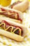 Grilled hot dogs with mustard, ketchup and relish