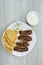 Grilled kebabs with pita bread, chopped onion and yogurt sauce