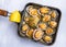 Grilled limpets in the pan served with lemon