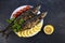 Grilled mackerel fish in a pan with vegetables. horizontal view from above