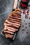 Grilled marbled beef steak. Black background. Top view