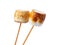 Grilled marshmallows on sticks isolated on white