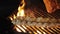 grilled meat. close-up. juicy pork ribs are grilled on blazing fire, lying on black grill grid, in a restaurant kitchen