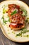 Grilled meat on pita bread on a bright oval plate. Dark wooden background. Restaurant menu