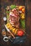 Grilled meat, sliced â€‹â€‹tomahawk beef steak with spices, french fries and vegetables