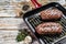 Grilled meat Top Blade steaks in a frying pan. Gray background. Top view. Copy space