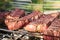 Grilled meat on a wire rack. Steaks barbecue on a brazier. Outdoor cooking