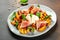 Grilled peach salad with mozzarella, prosciutto ham, basil, olive oil, Restaurant menu, dieting, cookbook recipe top