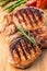 Grilled pork chop with rosemary leaf on wooden board