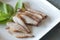 Grilled Pork Neck,  Thai Food. close up Charcoal-boiled Pork Neck on a plate white is a Popular Appetizer in Thailand. selected