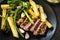Grilled porterhouse steak with broccolini shallots french fries and mustard