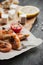 Grilled prawns on the peace of paper with tomatoes and cheese on the wooden board