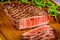 Grilled prime ribeye beef steak on wooden board