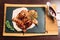 Grilled quails in the restaurant on a wooden plate