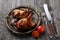 Grilled quails on wooden background