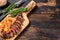 Grilled ramp cap steak on a cutting board. Dark wooden background. Top view. Copy space