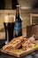 Grilled Reuben Sandwich with dark beer on wooden cutting board