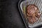 Grilled ribeye steak on grill iron pan on grunge metal background, close up.