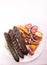 Grilled, roasted vegan sausages on a plate, selective focus. Composition with buckwheat blood sausages, isolated.