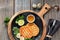 Grilled round slices of Greek cheese with honey, green salad and quail egg. Flat lay on rustic wood