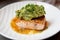 Grilled salmon fillet with guacamole and crushed nuts