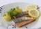 Grilled salmon fish filets on a plate with Potatoes, parsley and slices of lemon. Close up stock photo