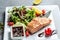 Grilled Salmon fish steak with fresh vegetables salad, Healthy salad for keto diet, friendly salmon with vegetables diet dish.